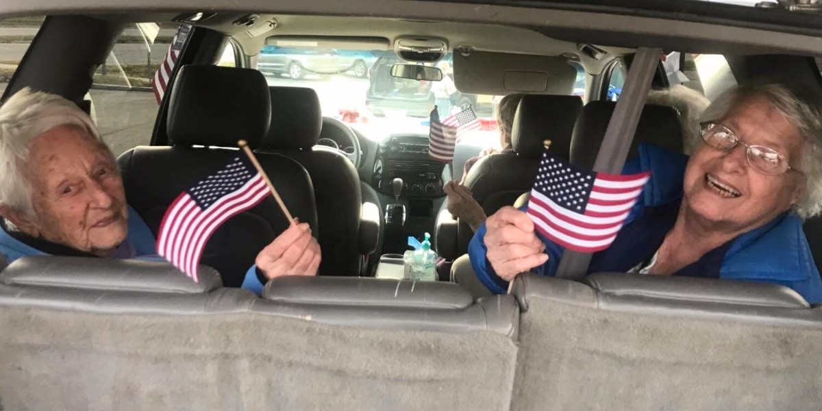 riding in a parade with american flags