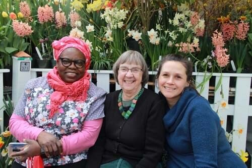 three women on bench smiling